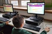 Pupils using a computer during live chat at St Bridgets Primary