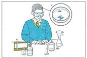 A student planning a crystalisation experiment with lab equipment