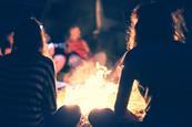Teenagers sitting around a campfire