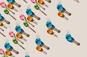 Lines of laboratory glassware containing colour liquids. Each line has fewer items in it.