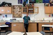 A chemistry teacher in a science classroom