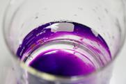 A photograph showing potassium permanganate in a glass beaker