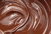 A full-frame, close-up image of a swirl of melted chocolate