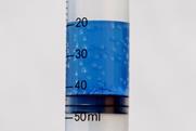 A test tube of boiling water at room temperature, with blue food dye for clarity