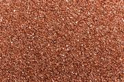A full-frame photograph of small copper granules