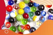 A group of spherical marbles of different sizes and colours