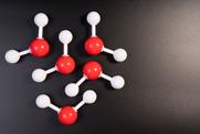 A photograph of 3D particle models illustrating molecules of water