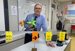 Graham Hewston holding a balloon model of electron orbitals in his science classroom