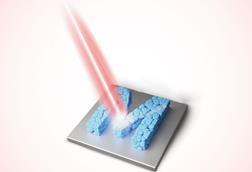 A laser targets an M made of squished blue blobs on a metallic sheet