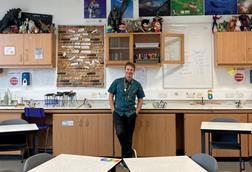 A chemistry teacher in a science classroom