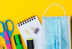 An image showing school supplies and a face mask