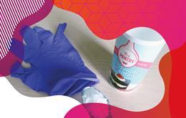 Photo of bicarbonate of soda, a teaspoon and a purple plastic glove