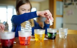 Young girl dying water different colours