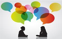 Colourful speech bubbles above two women in conversation in silhouette