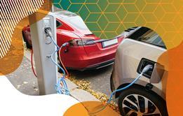 Photo of two electric cars plugged into a charging station