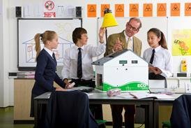 A science teacher discusses a environmental project with his high school students