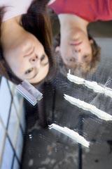 Teens staring at lines of Cocaine on a glass mirror