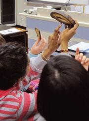 Students holding the objects used