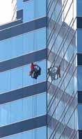 A window cleaner on a skyscraper