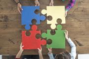Working together joining large jigsaw pieces