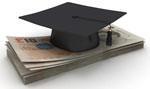 A graduation cap resting atop some money