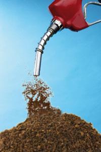 Coffee grounds being poured from a fuel pump
