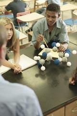 Students discussing a chemical structure