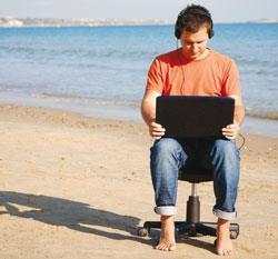 On a beach in an office chair listening to a podcast