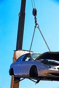 A car being lifted in a scrapyard