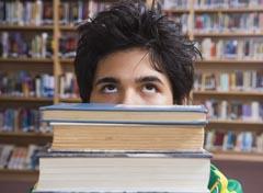 Holding a stack of books