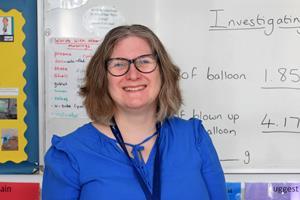 A teacher in front of a white board