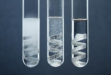 An image showing three test tubes, each containing magnesium strips in hydrochloric acid solutions of different concentrations