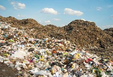 A photo of a landfill with a mountain of plastic waste