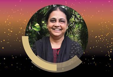 A photograph of Professor Savita Ladage, surrounded by a pink, gold and black border