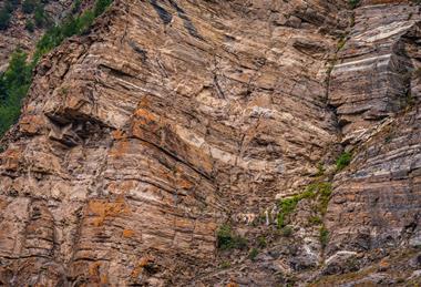 A photograph of a cliff showing layers or strata of limestone rock