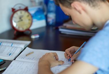 A teenage boy does homework