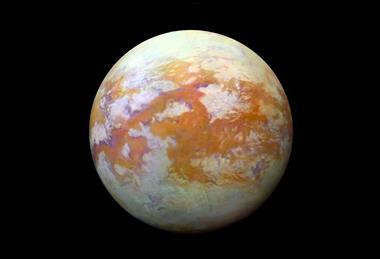 The whole surface of a moon showing red and white patches