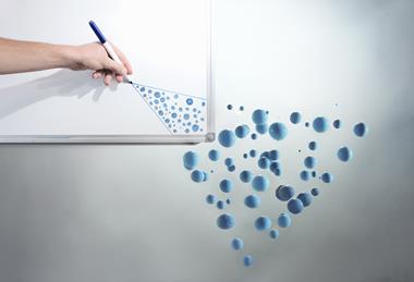A photo of a hand drawing circles on a whiteboard that turn into blue spheres
