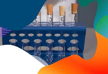Test tubes marked A to F in a blue test tube holder; each one contains some clear liquid and is sealed with a bung