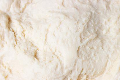 A close-up photograph of raw yeast dough