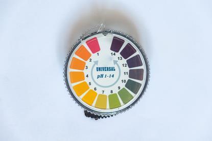 A circular plastic chart with the different possible colours of universal indicator, used for determining the pH of a solution 