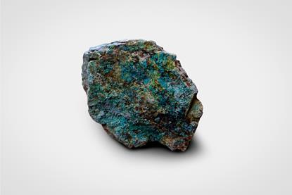 A macro photograph of a piece of rock with malachite (copper ore)