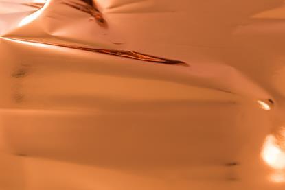 A full-frame image of creased copper foil
