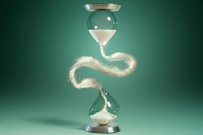 An hourglass that has been split in two and the sand swirls in the space between.