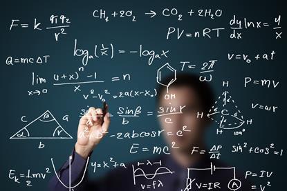 Teacher writing various maths and science formulae