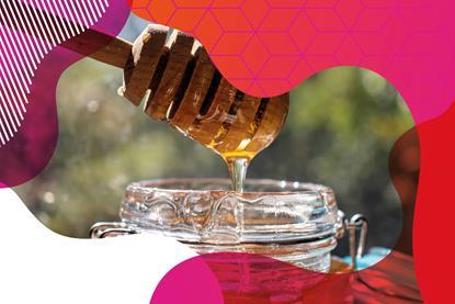 Photo of honey running off a honey dipper back into the jar