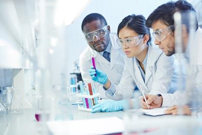 3 students in a lab looking at test tubes