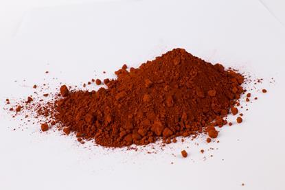 A small heap of powdered red iron oxide pigment