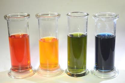 Four glass containers with bromothymol blue indicator solution displaying different colours, including red, yellow, green and blue