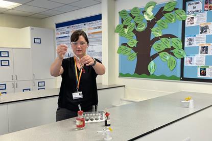 A science teacher doing some practical chemistry